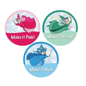 May include: Three round stickers featuring a cartoon fairy with a wand. The stickers have a blue, green, and pink background with the text "Make it Blue!" "Make it Green!" and "Make it Pink!"