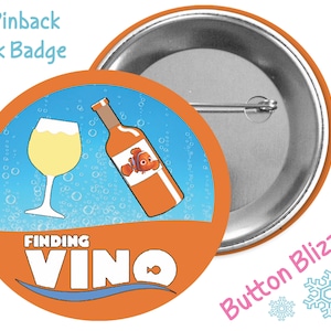May include: A 3-inch pinback park badge with an orange background and a blue circle in the center. The circle features a glass of white wine and a bottle of wine with a cartoon fish on the label. The text "FINDING VINO" is written in white letters below the circle.