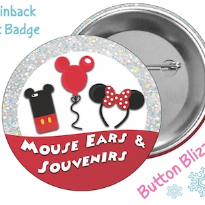 May include: A 3-inch pinback park badge with a red background and white circle. The circle features a Mickey Mouse phone, a red balloon with Mickey Mouse ears, and a Minnie Mouse headband with red polka dots. The text "Mouse Ears & Souvenirs" is written in white on the red background. The badge is labeled "Button Blizzard" in pink text.