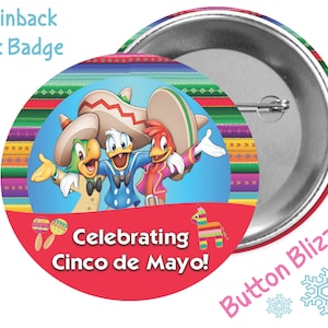 May include: A 3-inch pinback button featuring Donald Duck, José Carioca, and Panchito Pistoles dressed in traditional Mexican attire. The button has a red background with the text "Celebrating Cinco de Mayo!" and a maraca and a piñata.