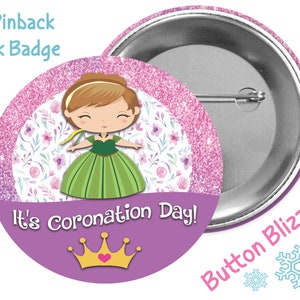 May include: A 3-inch pinback button with a pink glitter background and a cartoon image of a princess in a green dress. The text "It's Coronation Day!" is printed on the button with a gold crown and a pink heart.