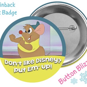 May include: A 3-inch pinback button featuring a cartoon mouse with a yellow shirt and a blue hat. The text on the button reads "Don't like Disney? put Em' Up!"