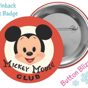 May include: A 3-inch pinback park badge featuring a red circle with a white inner circle. The inner circle has a cartoon image of Mickey Mouse's head with the text "Mickey Mouse Club" underneath. The badge has a silver back with a pin.