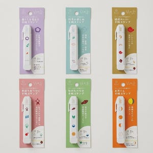 May include: Six white rectangular stick-style stamps are displayed on individual vertical cardboard backing cards in purple, light blue, gold, pink, green, and orange. Each stamp features small colorful icons and Japanese text.