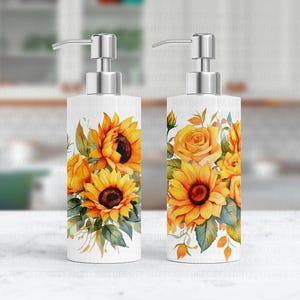 May include: Two white ceramic soap dispensers with a pump top. The dispensers feature a watercolor design of sunflowers and roses in shades of yellow, orange, and green.