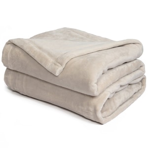 May include: A soft, plush beige blanket folded in thirds. The blanket is made of a soft, fuzzy material and is perfect for keeping warm on a cold night.