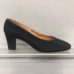 May include: Black satin pumps with a block heel.