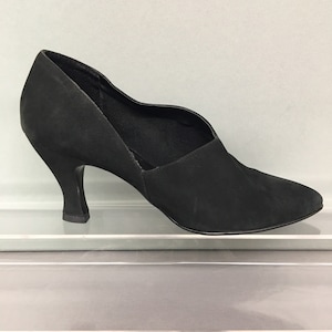 May include: Black suede heeled shoe with a pointed toe and a cut-out design on the side.