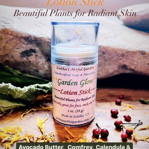 May include: A white plastic tube with a yellow lotion stick inside. The label reads "Garden Glow Lotion Stick" and lists ingredients including avocado butter, comfrey, calendula, rose hip infused apricot kernel oil, beeswax, hemp seed oil, essential oil of geranium, and matcha tea powder. The label also states "Beautiful Plants for Radiant Skin" and "Keitha's Artful Garden Handcrafted Soap & Miscellany".