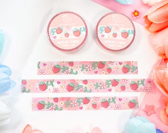 May include: Three rolls of pink and white washi tape with a strawberry and floral design. The tape is labeled "Washi Tape" and "Love & Luck".