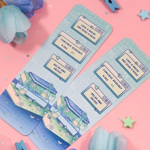 May include: Two blue and green illustrated bookmarks with a computer screen design. The text on the bookmarks reads "Take a break and read a book" and "Continue reading? Yes/No". The bottom of the bookmark says "Relax and enjoy!"