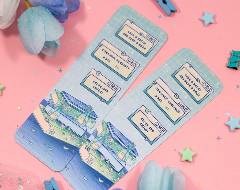 May include: Two blue and green illustrated bookmarks with a computer screen design. The text on the bookmarks reads "Take a break and read a book" and "Continue reading? Yes/No". The bottom of the bookmark says "Relax and enjoy!"