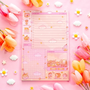 May include: A pink notepad with a fall theme, featuring illustrations of pumpkins, clouds, and stars. The notepad includes sections for to-do lists, notes, and a section labeled "Tomorrow". Decorative flowers and clouds surround the notepad.