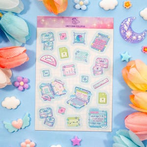 May include: A sheet of stickers with a school theme, featuring a calculator, laptop, and other school supplies. The stickers are in shades of blue, pink, and green. The sheet is titled "Unicorn Eclipse". Decorative flowers and shapes surround the sheet.