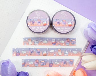 May include: Two rolls of purple and pink washi tape with a pastel galaxy design. The tape features a repeating pattern of clouds, stars, and coffee cups. The tape is labeled "Unicorn Eclipse Washi Tape 10mm x 10m".