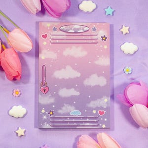 May include: A rectangular notepad featuring a purple and pink gradient background with a cloud and star pattern. The design mimics a locker door with horizontal vents, a top oval slot, and a heart-shaped padlock illustration on the left side.