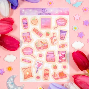 May include: A sheet of stickers featuring a variety of cute cartoon food items, including a lunchbox, a juice box, a candy bar, and a peach. The stickers are on a pink and white grid background with the text "Unicorn Eclipse" at the top.