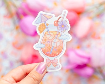 May include: A colorful sticker featuring a cartoon cocktail in a tall glass. The drink has ice cubes, a straw, and is garnished with a cherry, orange slice, and a flower. A small umbrella and clouds are also included in the design.