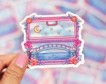 Puede incluir: Una pegatina con una ventana rosa y azul con una luna creciente, estrellas y un puente sobre una masa de agua azul. La ventana está rodeada de flores y enredaderas.