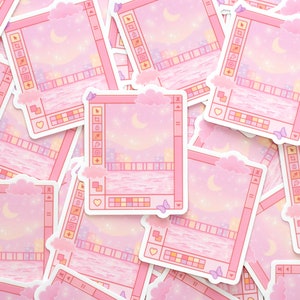 May include: A stack of pink and white stickers with a pixelated city skyline and a crescent moon. The stickers have a computer window design with a toolbar and a color palette.