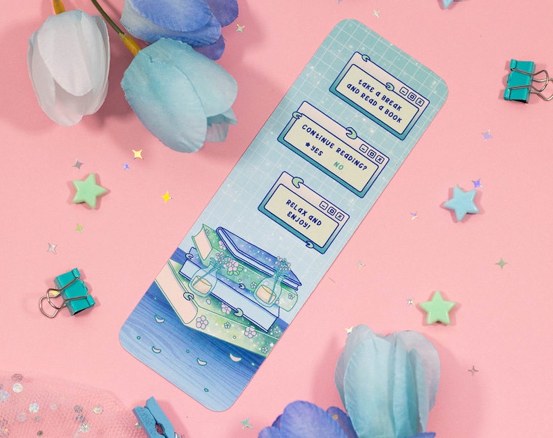 May include: A blue and green bookmark with a stack of books and a computer screen with the text "take a break and read a book", "continue reading? yes no", and "relax and enjoy!"