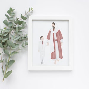 May include: A framed print showing an illustration of two figures holding hands. One figure is in a red robe and the other is in a white suit. Eucalyptus leaves are on the left side of the frame.