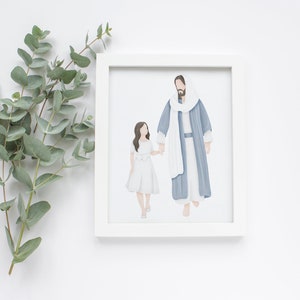 May include: A framed print featuring an illustration of a figure in a blue robe holding hands with a girl in a white dress. The artwork is set against a white background, with eucalyptus leaves in the upper left corner.