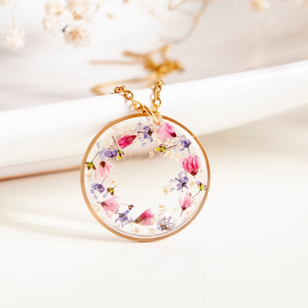 Golden pendant with a crown of pink and blue flowers, resin jewelry.