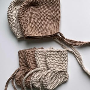 May include: A set of three ceramic mugs with a speckled, matte finish. The mugs are in shades of cream, light gray, and dark gray. Each mug has a simple, minimalist design, perfect for coffee or tea.