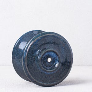 May include: A blue ceramic pour-over coffee dripper with a single hole in the center.