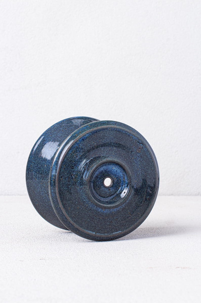 May include: A blue ceramic pour-over coffee dripper with a single hole in the center.