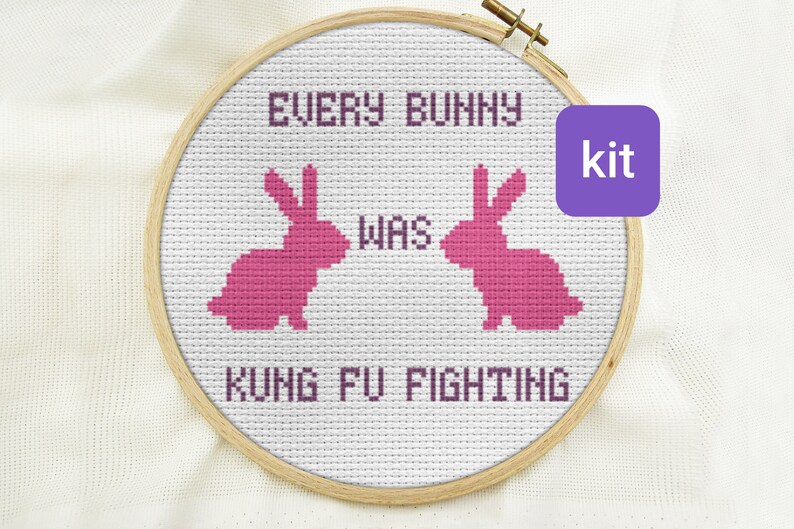 May include: A cross-stitch embroidery kit featuring two pink bunny silhouettes with the text "Every bunny was kung fu fighting".