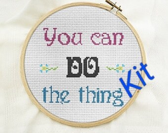 May include: A cross-stitch kit in a wooden hoop. The text "You can DO the thing" is stitched in various colors. The word "Kit" is written in blue.