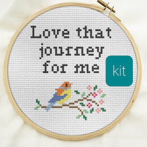 May include: Cross stitch kit featuring a bird on a branch with pink flowers and the text "Love that journey for me".