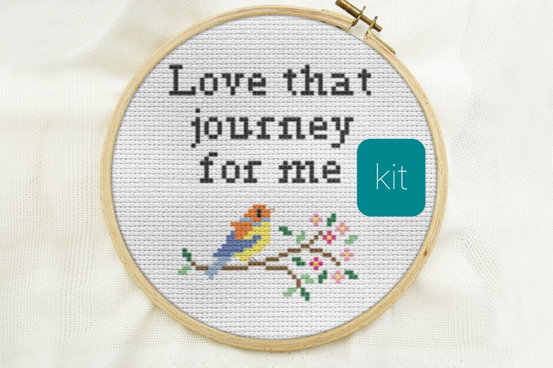 May include: Cross stitch kit featuring a bird on a branch with pink flowers and the text "Love that journey for me".