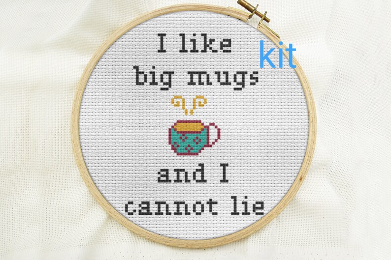May include: Cross stitch embroidery hoop with the text "I like big mugs and I cannot lie" and a small illustration of a steaming mug.