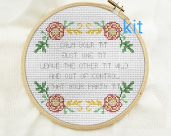 May include: A circular wooden embroidery hoop containing white Aida fabric with a cross-stitch design. The design features floral motifs in red, yellow, and green, surrounding the black text: CALM YOUR TIT JUST ONE TIT LEAVE THE OTHER TIT WILD AND OUT OF CONTROL THAT YOUR PARTY TIT kit.