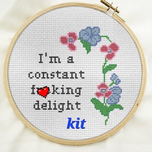 May include: Cross stitch pattern kit featuring a floral design with pink and blue flowers and the text "I'm a constant f**king delight kit".
