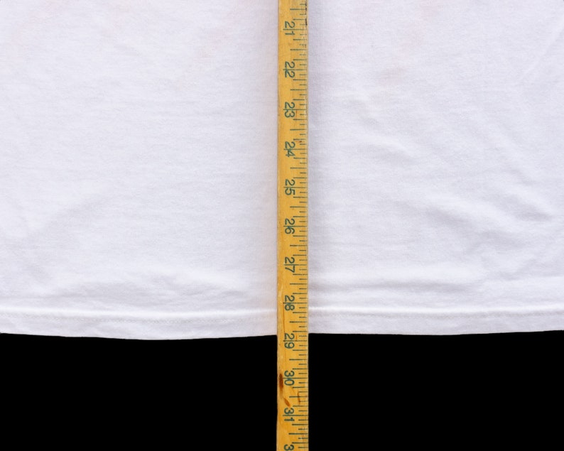May include: White t-shirt with a hem that measures approximately 27 inches in length.
