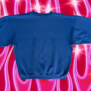 May include: A solid blue sweatshirt with a crew neck and long sleeves. The sweatshirt is made of a soft, comfortable material.