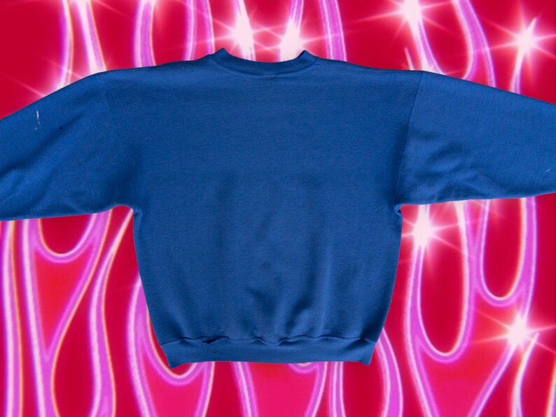 May include: A solid blue sweatshirt with a crew neck and long sleeves. The sweatshirt is made of a soft, comfortable material.