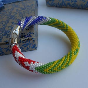 Idde de Orula con detalles de Shango y Yemaya mit Zeichen Oddi Sa