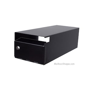 May include: A black, rectangular mailbox with a drawer and a lock. The mailbox has a simple, modern design and is made of metal. The drawer is open, revealing the interior. The website MailboxShoppe.com is printed on the side.