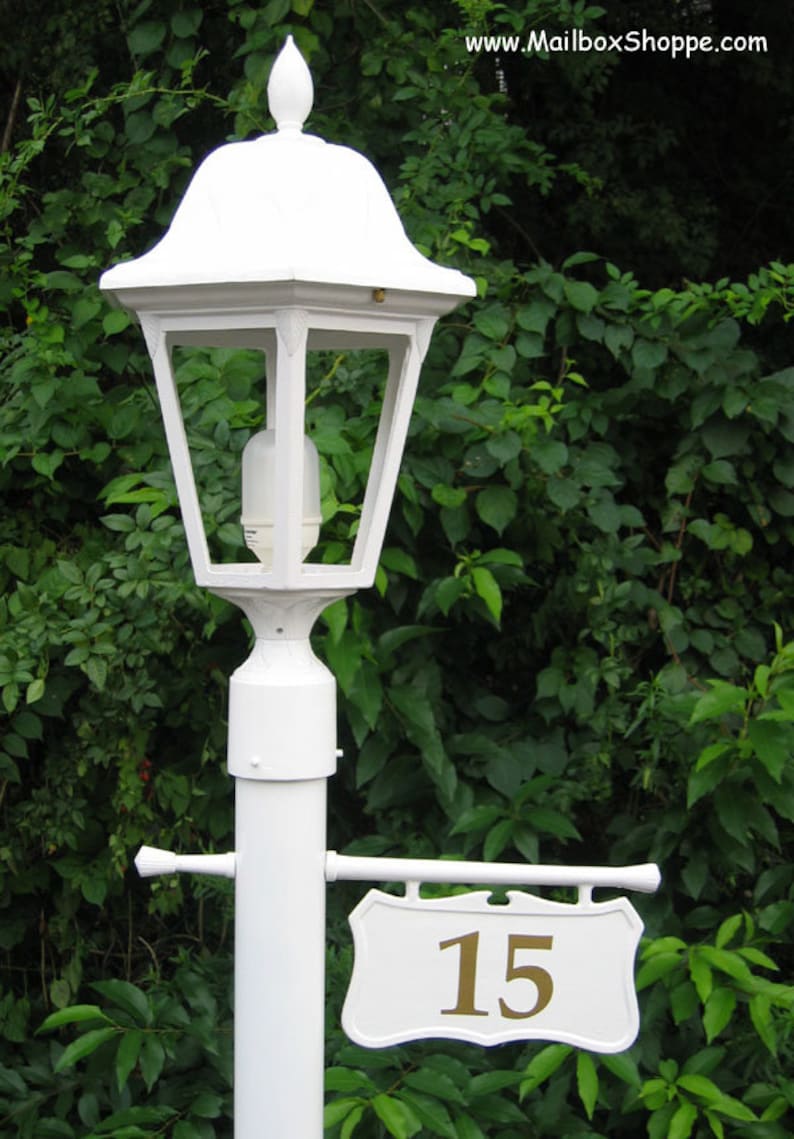 white lamp post with address sign