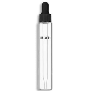 May include: A clear glass bottle with a black dropper top. The bottle has the word "RUACH" printed vertically in black. The bottle is rectangular and has a narrow, elongated shape.