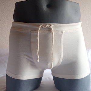 May include: White swim trunks with a drawstring waist.
