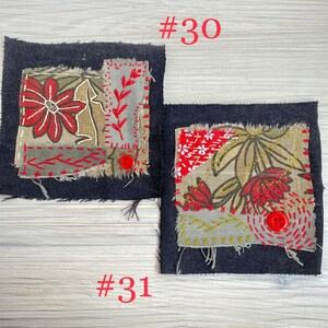 May include: Two square fabric patches labeled #30 and #31. Each features a dark denim base with layered, frayed-edge fabric scraps in olive green and red floral patterns, accented by red hand-stitched embroidery and a single small red button.
