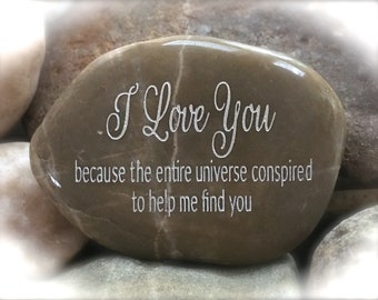 May include: A brown, smooth, heart-shaped stone with the words "I Love You because the entire universe conspired to help me find you" engraved on it.