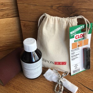 May include: A wood care kit with a brown bottle of wood polish, a white cloth, a small bag, and a black applicator. The packaging includes the text "Wachskitt lichtecht CLO F&Uuml;R HOLZ" and "SPONTOLZ".