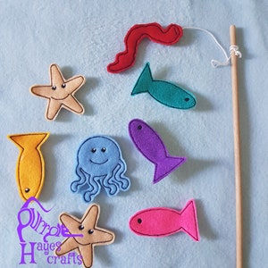 May include: Felt fish, starfish, and an octopus with a smiling face, attached to a wooden fishing rod with string. The felt pieces are in various colors, including red, blue, yellow, purple, and pink.